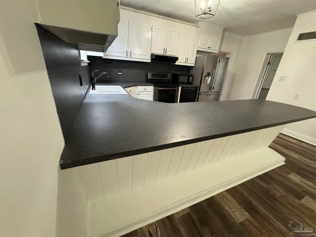 a view of a livingroom with wooden floor