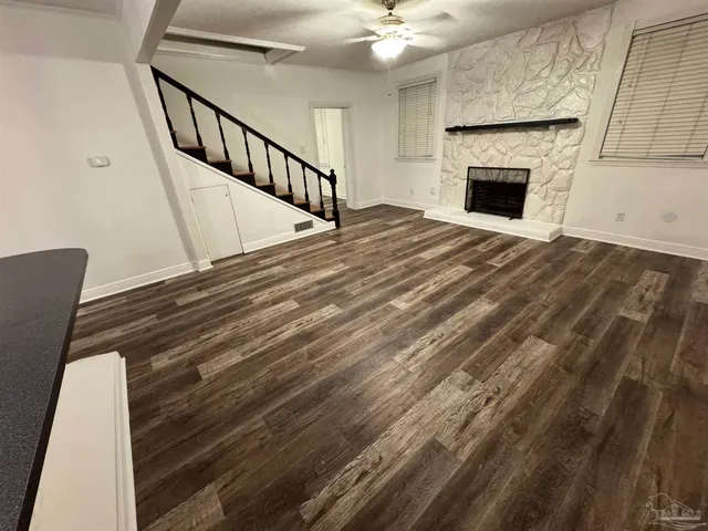 a view of wooden floor in a hall with wooden floor