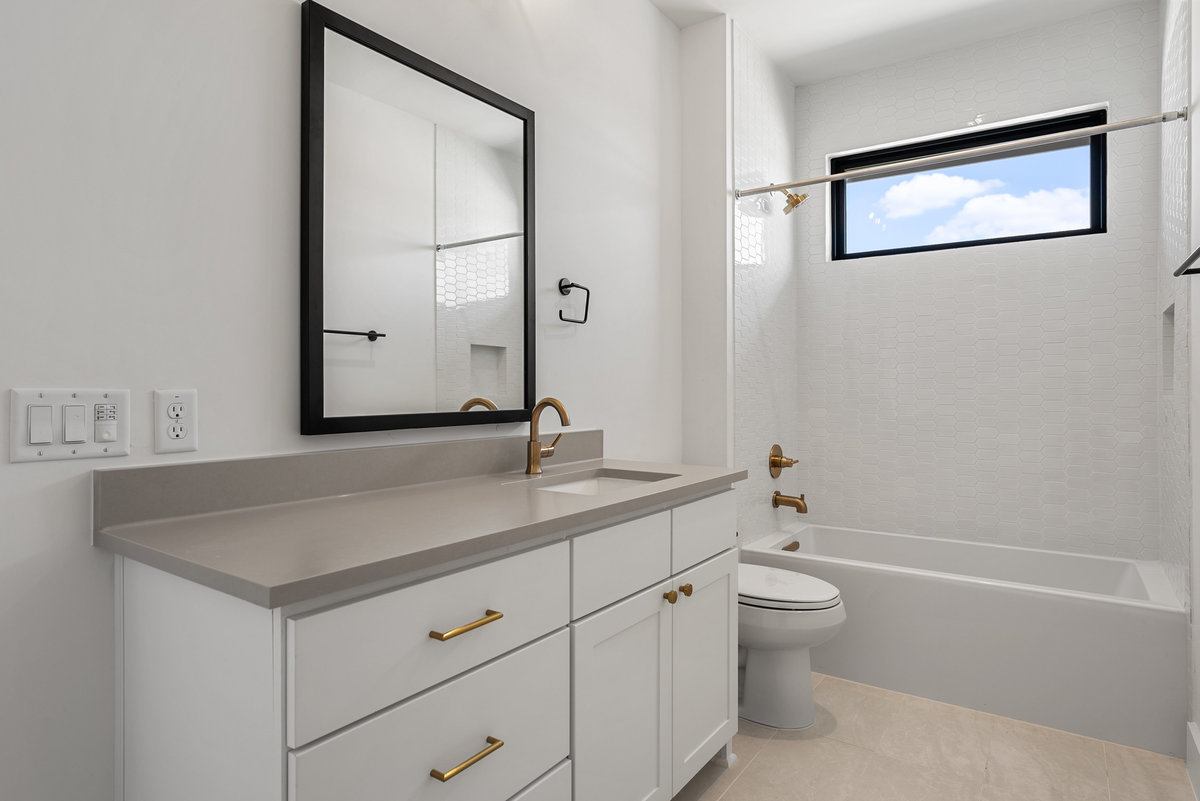 6010 Adhara Pass Austin, TX 78730 - Photo 34 of 38 a bathroom with a granite countertop sink mirror vanity and toilet