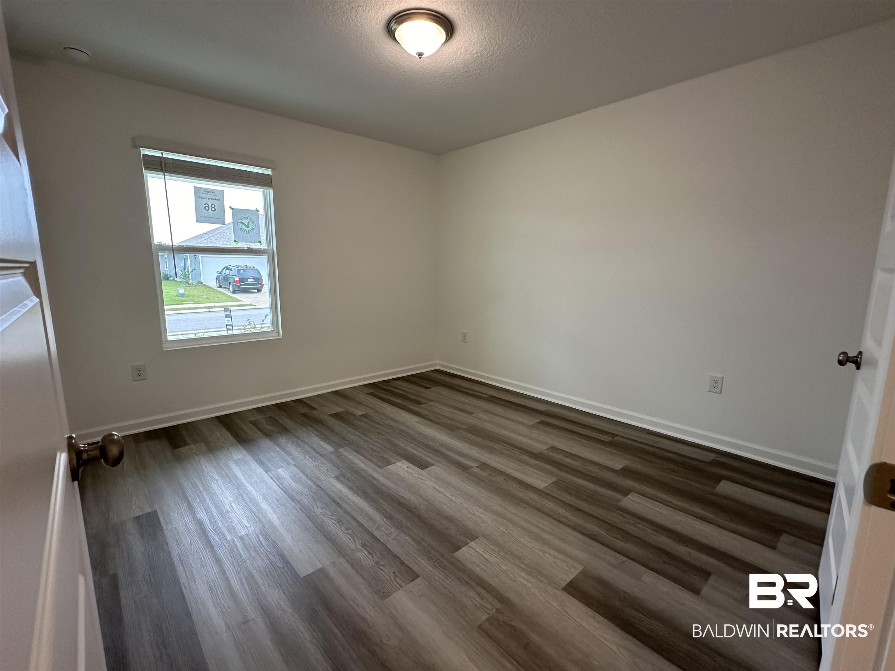 22275 Aleutian Avenue Foley, AL 36535 - Photo 21 of 72 Unfurnished room with dark wood-type flooring