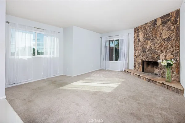 a view of empty room with a fireplace