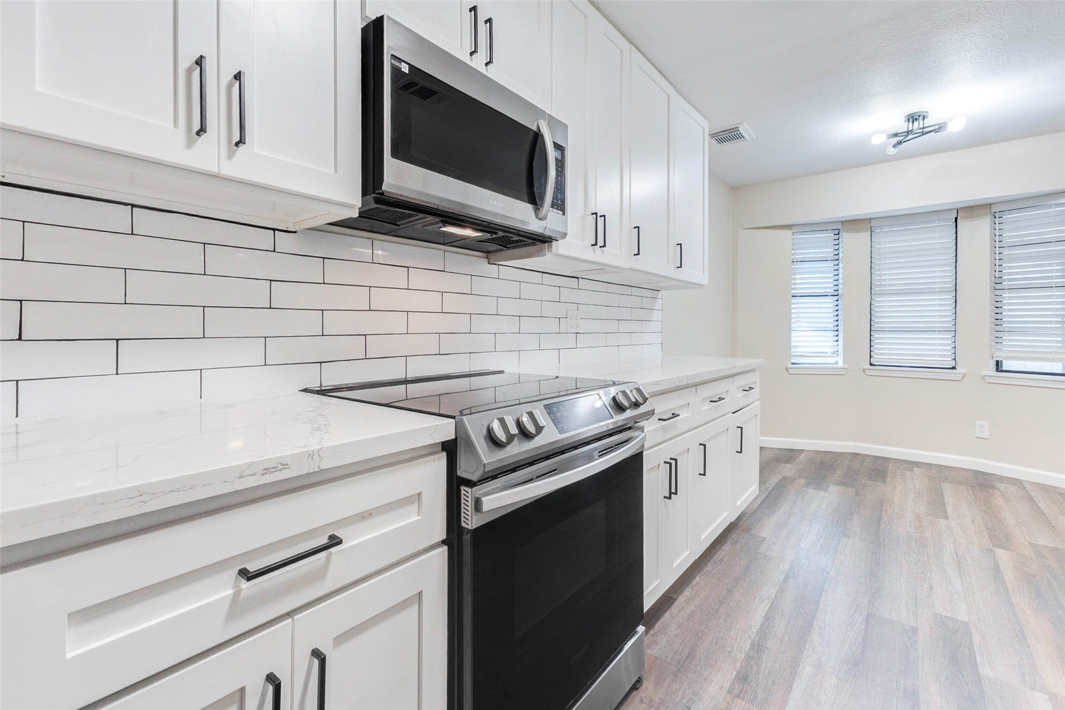 11222 Sagepark Lane Houston, TX 77089 - Photo 11 of 41 a kitchen with stainless steel appliances a stove microwave and sink