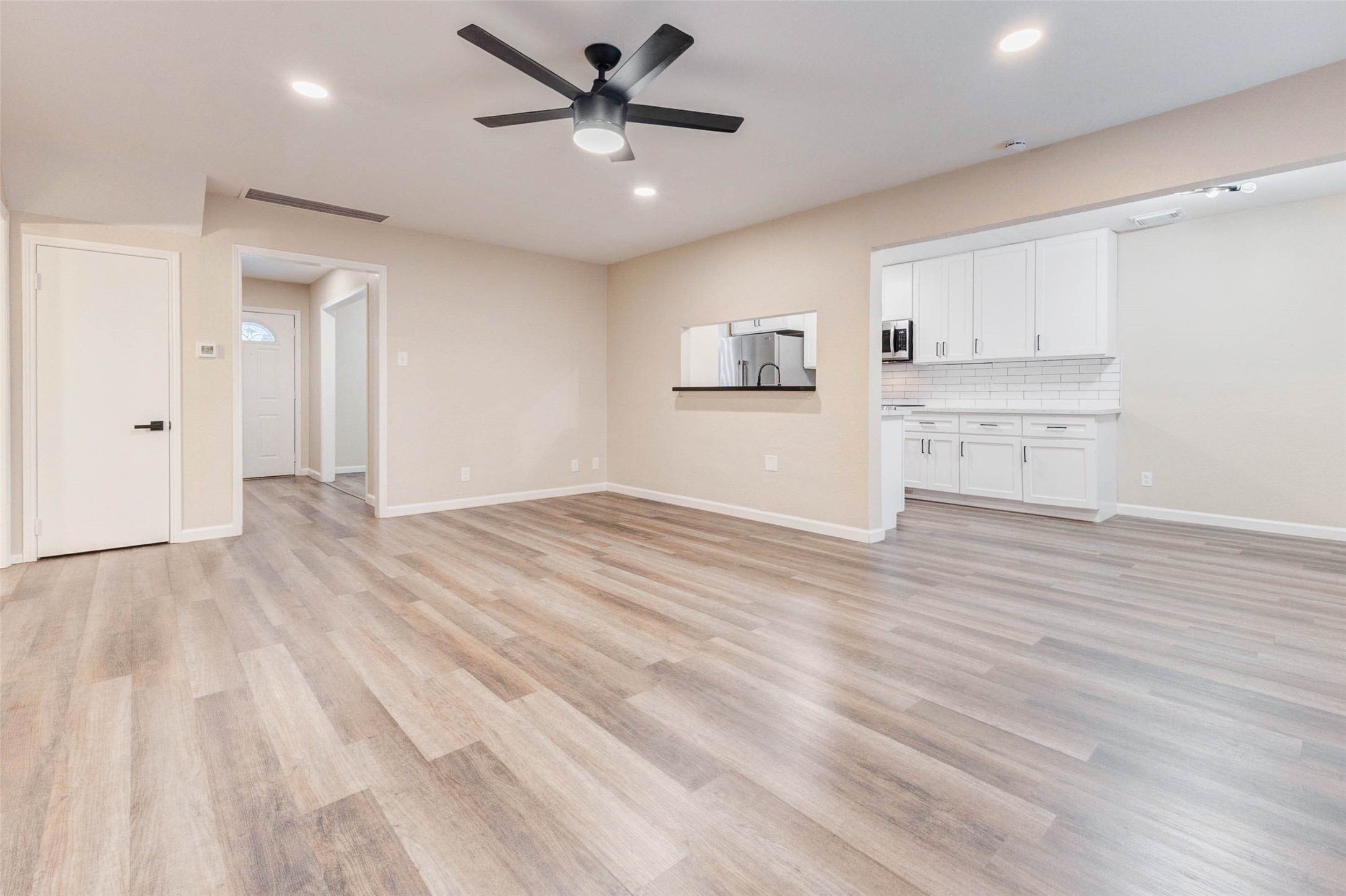 11222 Sagepark Lane Houston, TX 77089 - Photo 17 of 41 a view of a kitchen with wooden floor and a ceiling fan