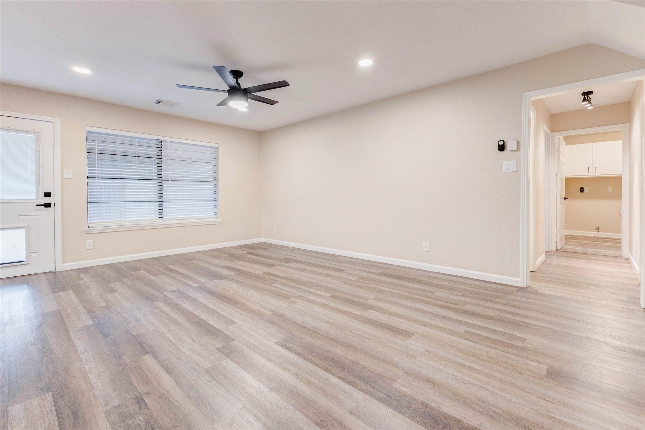 11222 Sagepark Lane Houston, TX 77089 - Photo 19 of 41 an empty room with wooden floor cabinet and windows