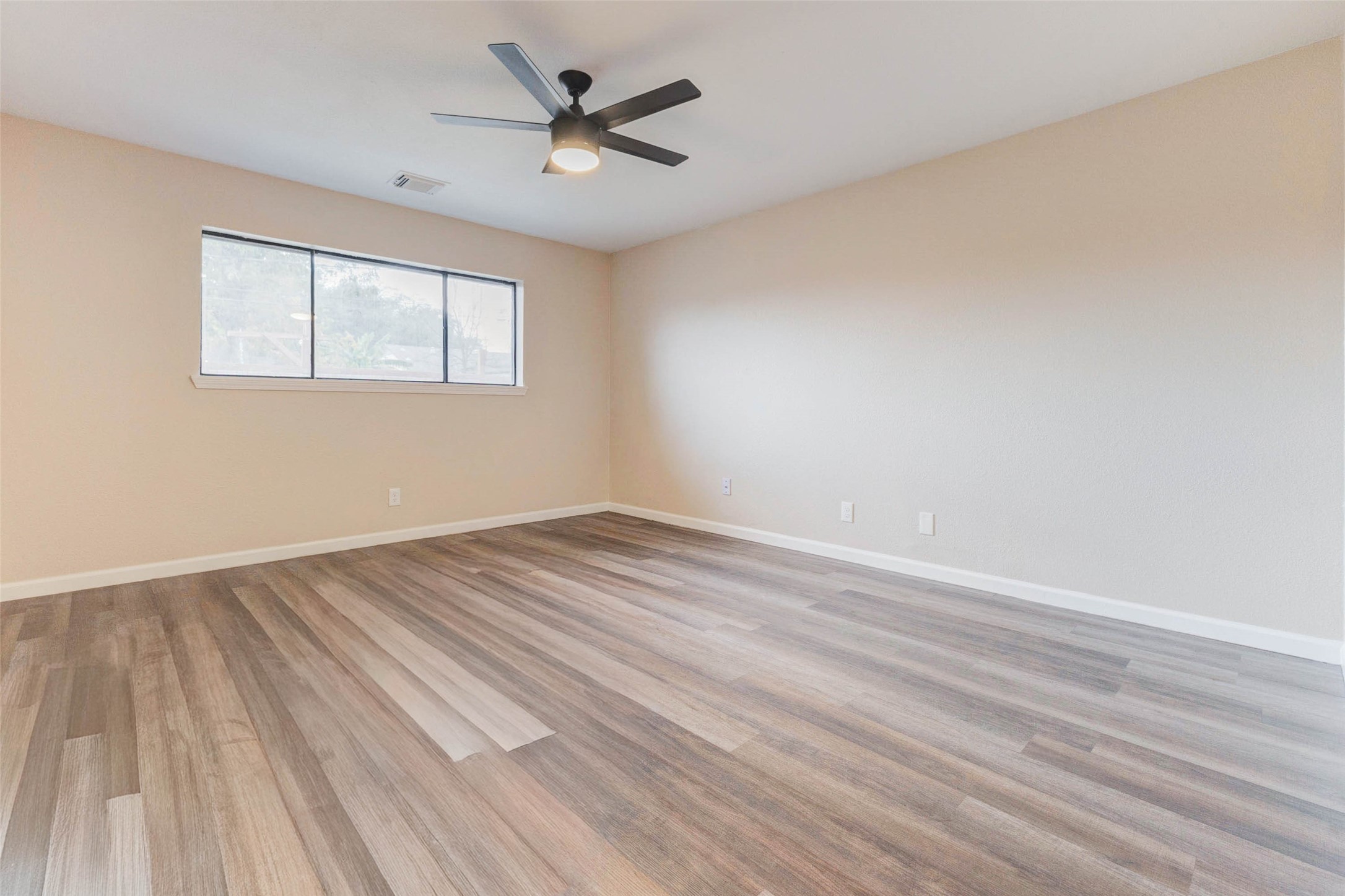 11222 Sagepark Lane Houston, TX 77089 - Photo 22 of 41 an empty room with wooden floor and windows