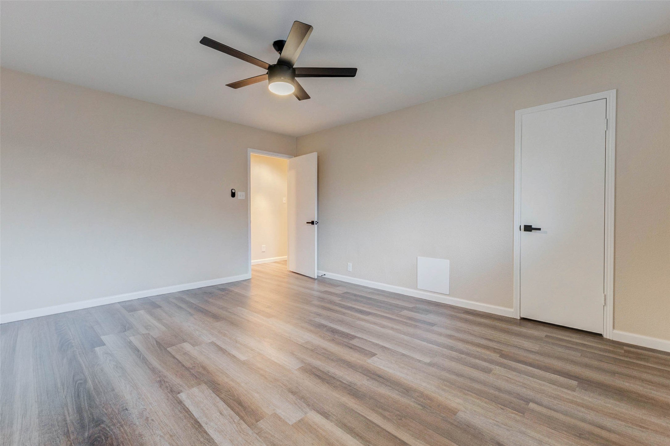 11222 Sagepark Lane Houston, TX 77089 - Photo 23 of 41 an empty room with wooden floor and ceiling fan