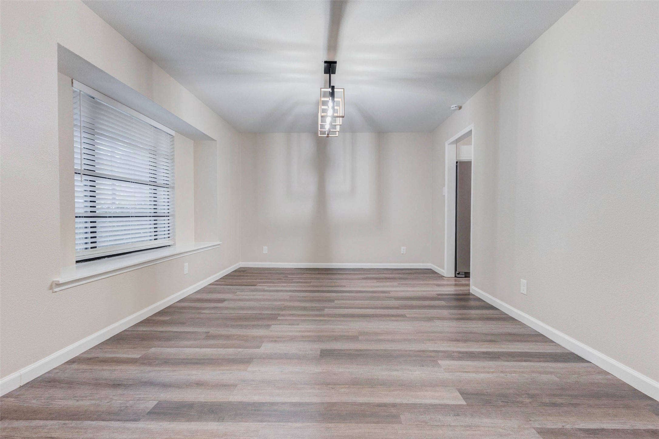 11222 Sagepark Lane Houston, TX 77089 - Photo 7 of 41 a view of an empty room with wooden floor and a window