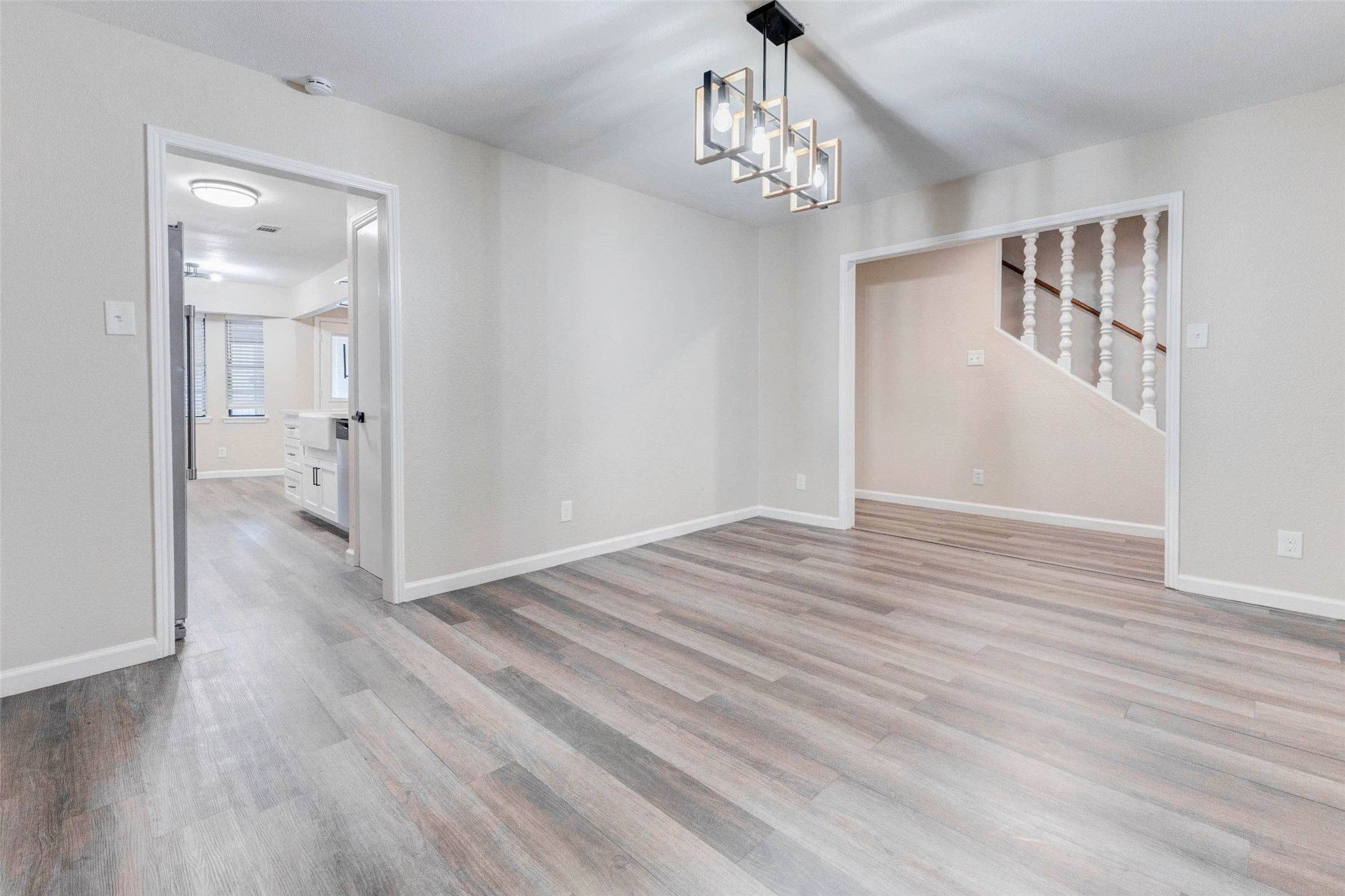 11222 Sagepark Lane Houston, TX 77089 - Photo 9 of 41 a view of a hallway with wooden floor and chandelier
