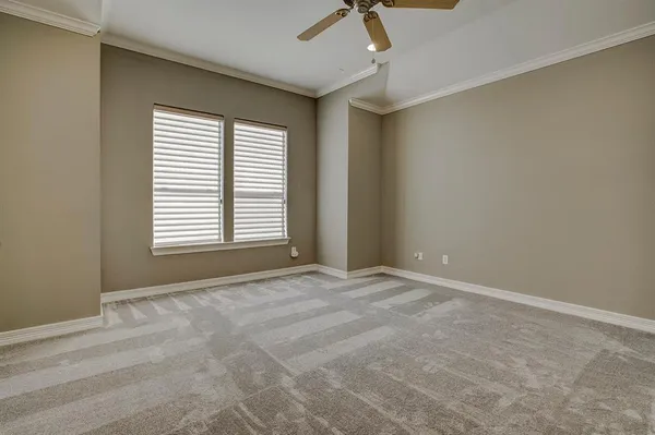 an empty room with closet and windows