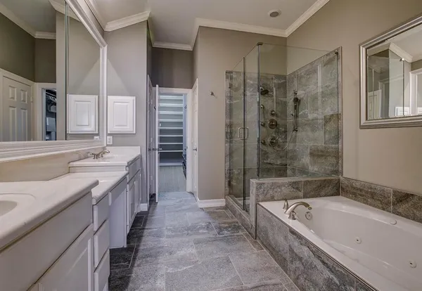a bathroom with a bathtub and shower