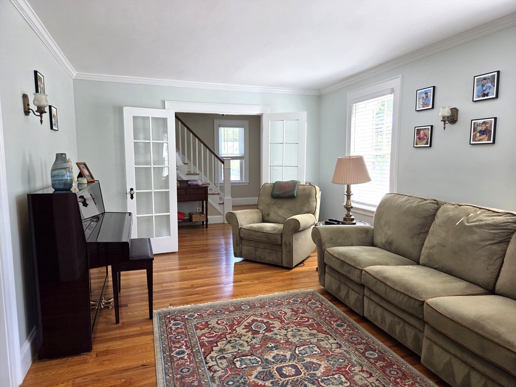 25 Waldeck Road Milton, MA 02186 - Photo 4 of 34 a living room with furniture wooden floor and a window