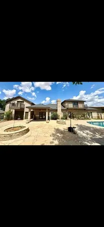 a view of a big yard with an outdoor seating