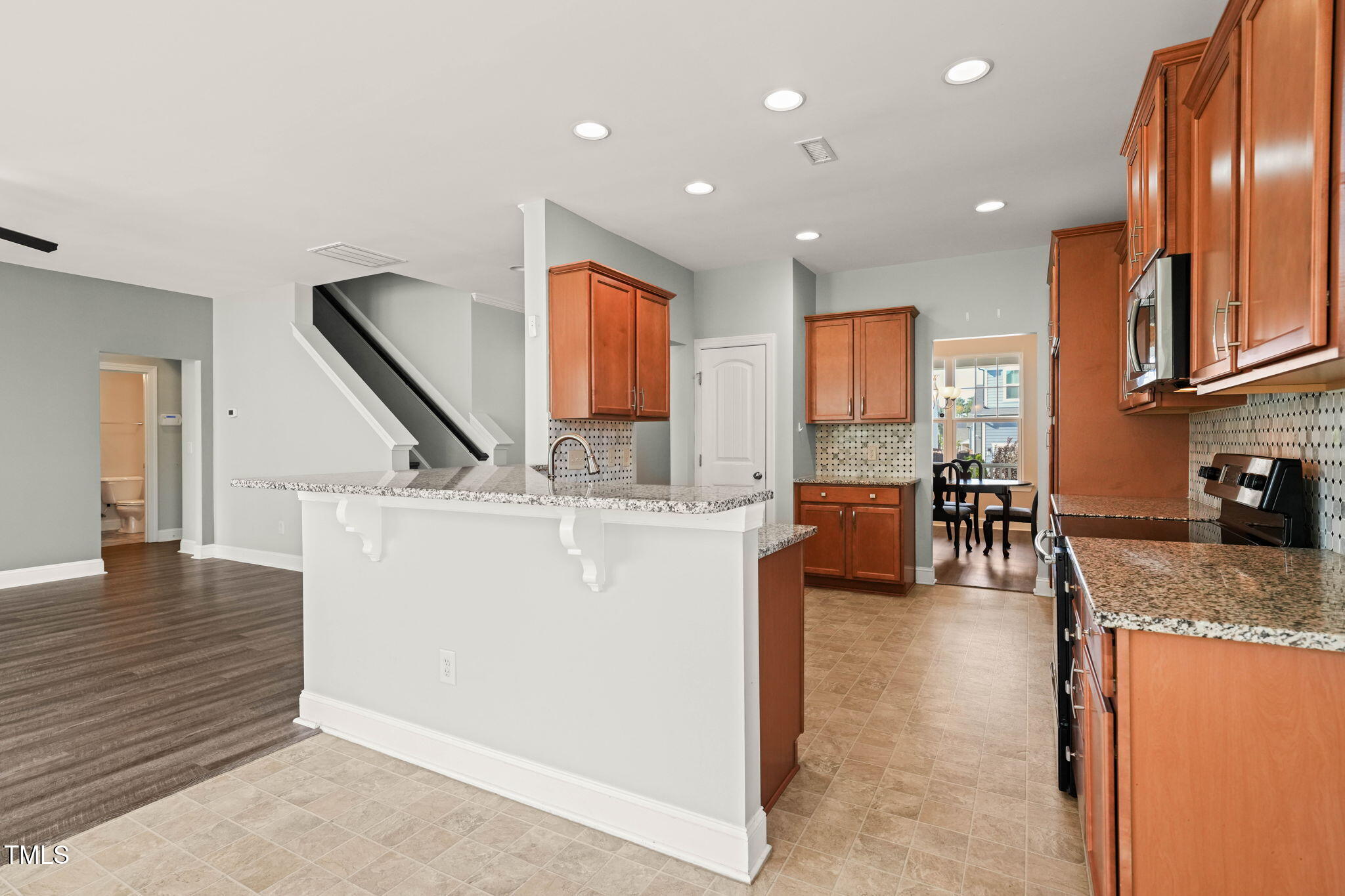 4508 Brintons Cottage Street Raleigh, NC 27616 - Photo 9 of 46 a view of a kitchen with kitchen island stainless steel appliances refrigerator stove microwave and cabinets