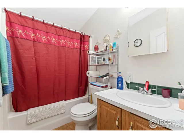 a bathroom with a sink a toilet and shower curtain