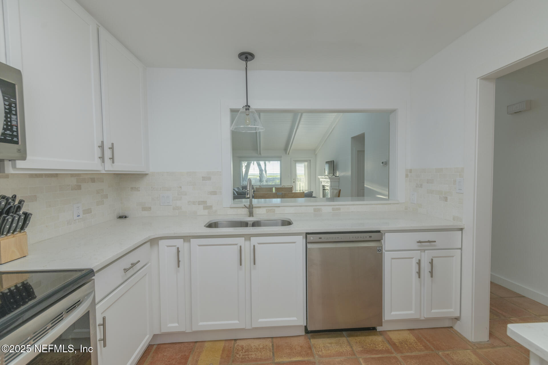 3426 Sea Marsh Road Fernandina Beach, FL 32034 - Photo 11 of 39 a kitchen with white cabinets and sink