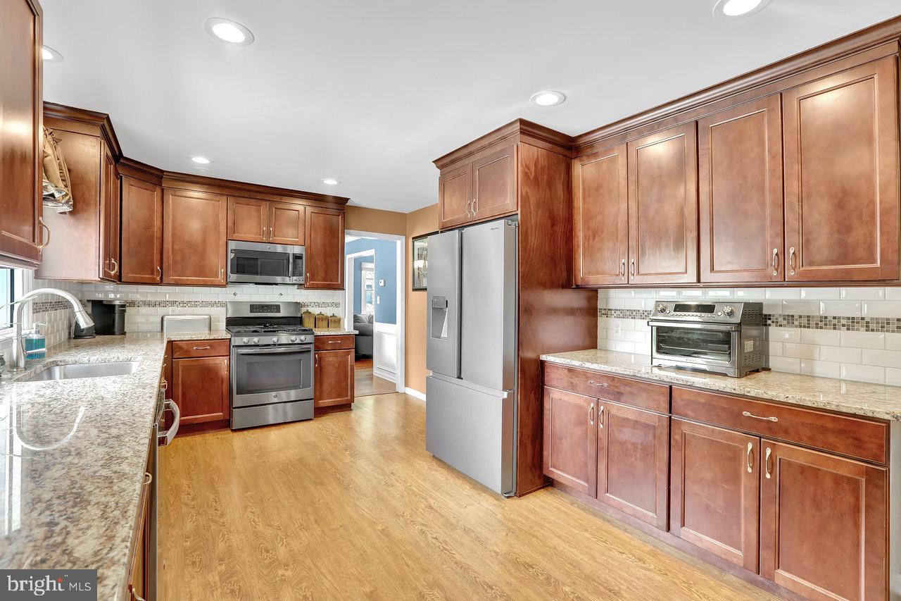 199 Applegate Drive Hamilton, NJ 08690 - Photo 13 of 40 a kitchen with stainless steel appliances granite countertop a refrigerator stove microwave and sink