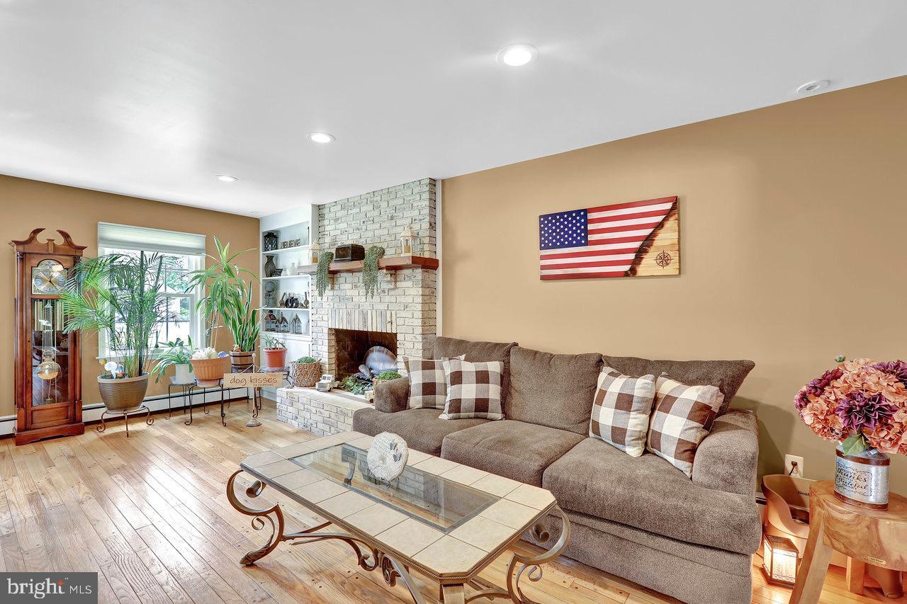 199 Applegate Drive Hamilton, NJ 08690 - Photo 15 of 40 a living room with furniture and a fireplace