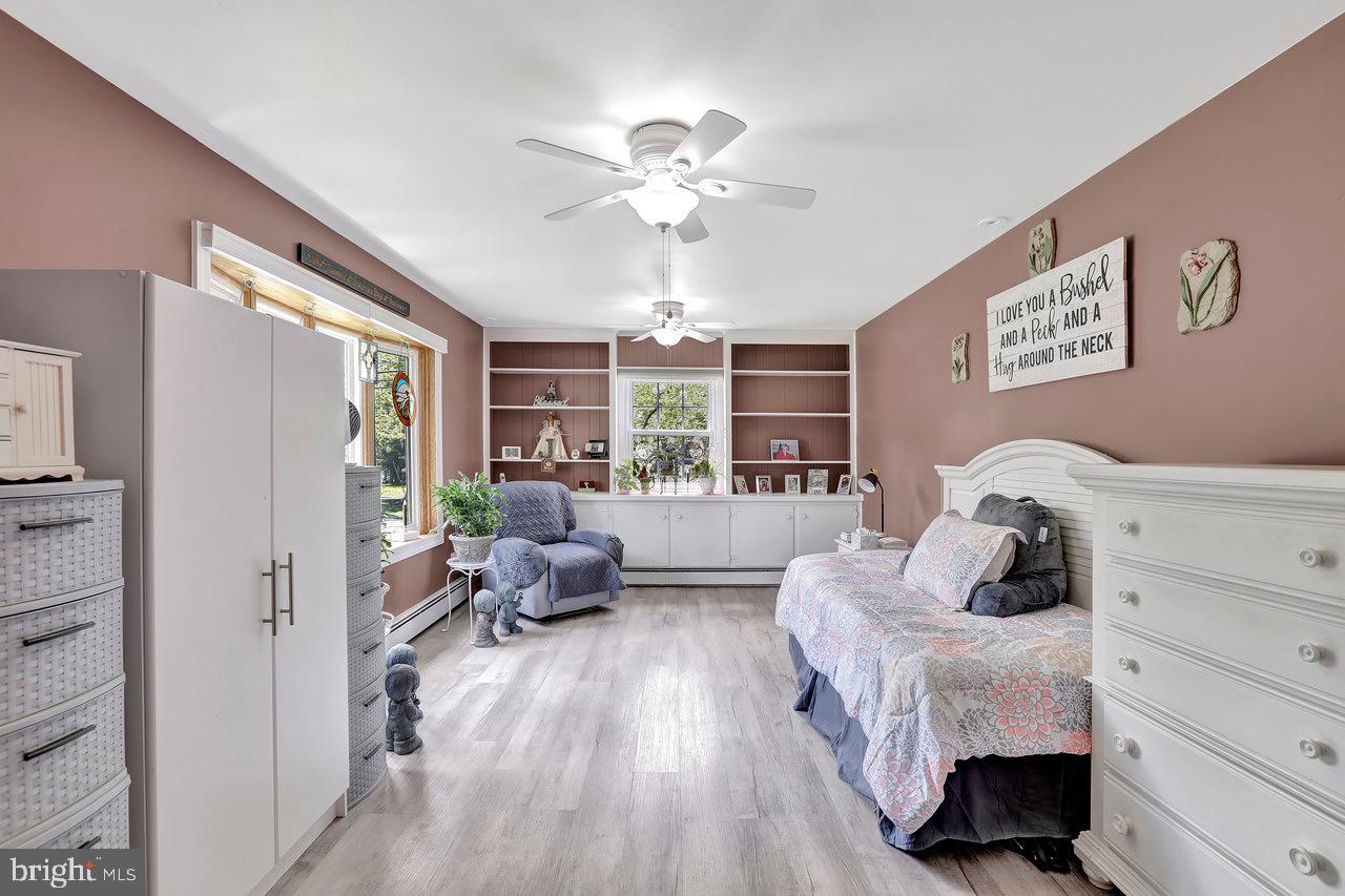 199 Applegate Drive Hamilton, NJ 08690 - Photo 19 of 40 a bedroom with a bed and wooden floor