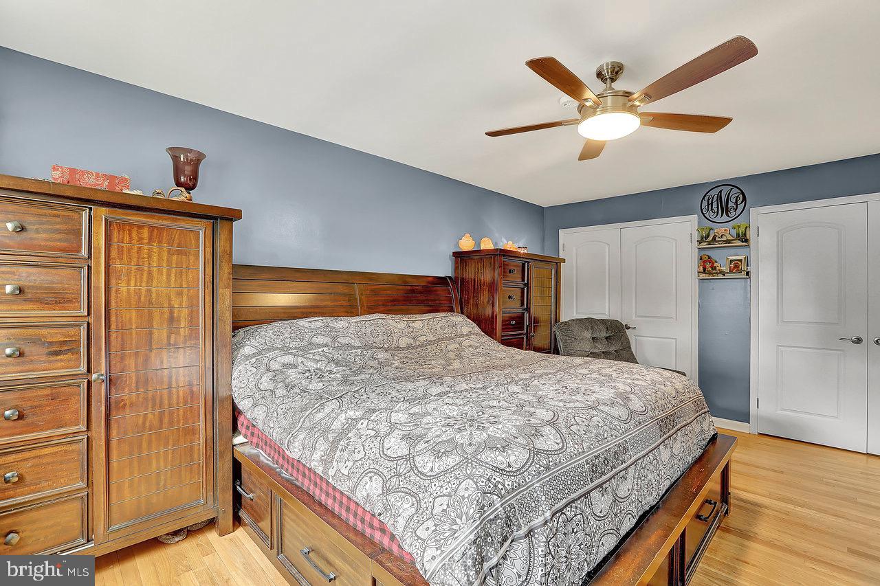 199 Applegate Drive Hamilton, NJ 08690 - Photo 22 of 40 a bedroom with a large bed and a chandelier