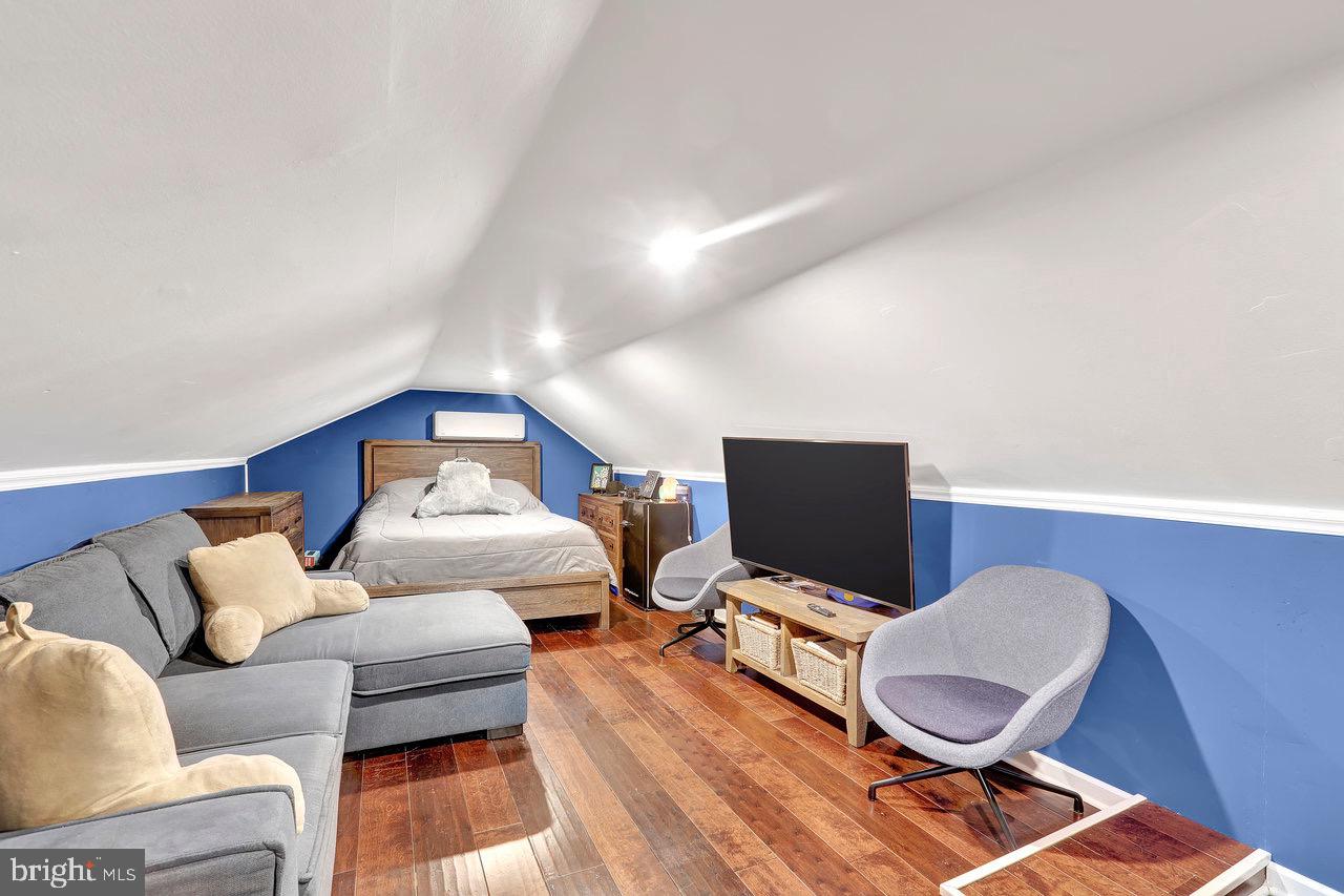 199 Applegate Drive Hamilton, NJ 08690 - Photo 29 of 40 a living room with furniture a flat screen tv and rug