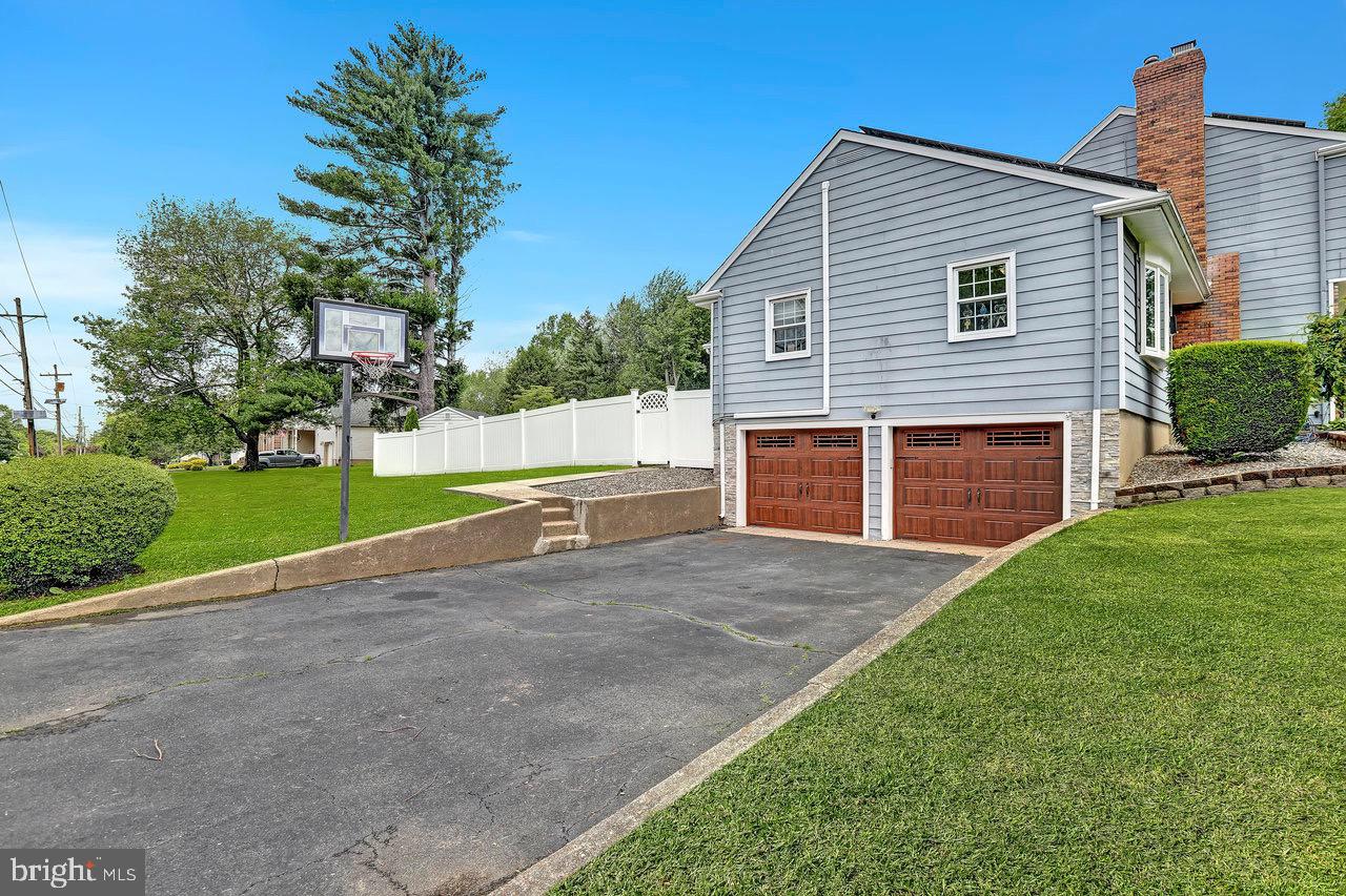 199 Applegate Drive Hamilton, NJ 08690 - Photo 30 of 40 a front view of a house with a yard and garage