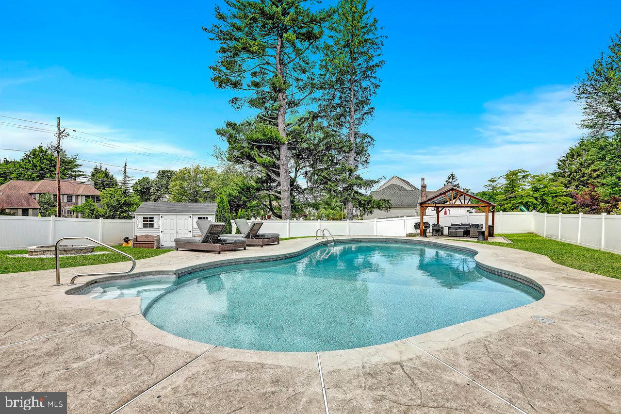 199 Applegate Drive Hamilton, NJ 08690 - Photo 34 of 40 a view of a swimming pool with a lounge chair