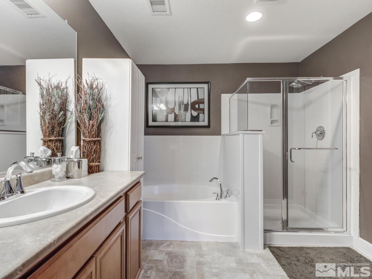 1960 Bears Ranch Drive Reno, NV 89521 - Photo 21 of 24 a bathroom with a granite countertop sink a large mirror and shower