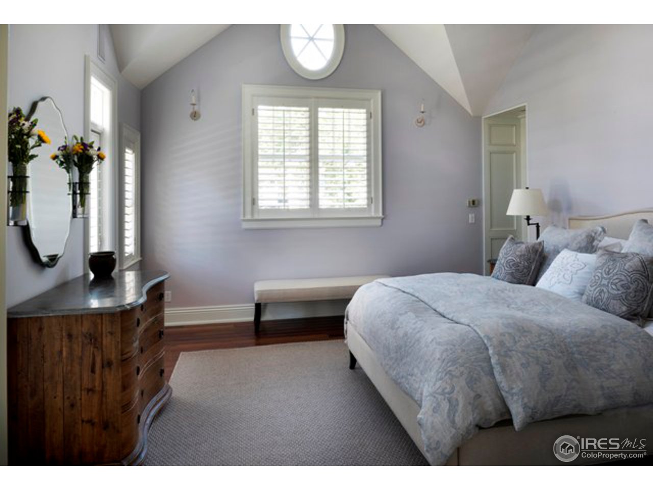 3189 5th Street Boulder, CO 80304 - Photo 17 of 25 a bedroom with a bed a mirror and a window