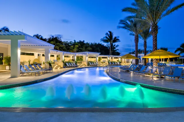 a view of a swimming pool with an outdoor seating and a yard