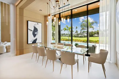 a dining room with furniture and a large window