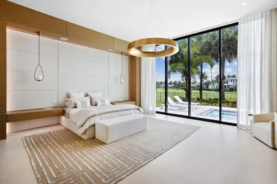 a bedroom with a large bed and a large window