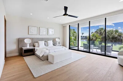 a bedroom with a large bed and a large window