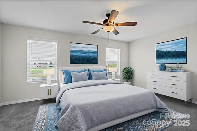 a bedroom with a bed a window and a flat screen tv