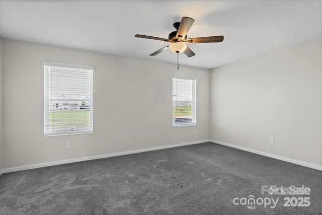 a view of a livingroom with a ceiling fan and window