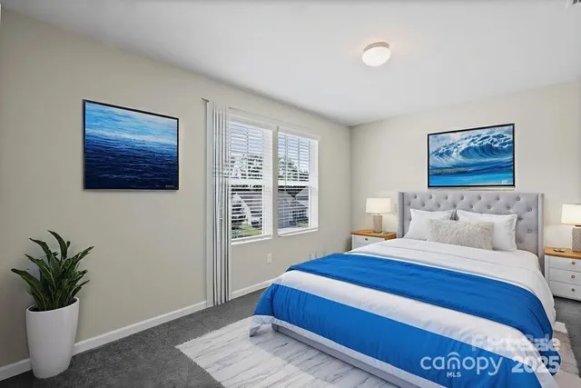 a bedroom with a large bed and a potted plant