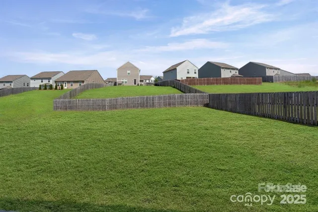 a view of an house with a big yard and potted plants