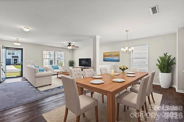 a view of a dining room with furniture window and wooden floor