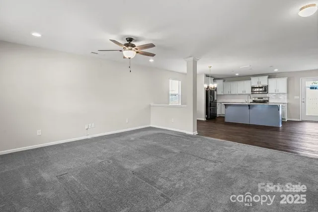a view of a kitchen with a sink and a stove top oven