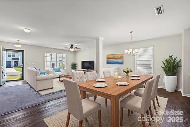 a view of a dining room with furniture window and wooden floor