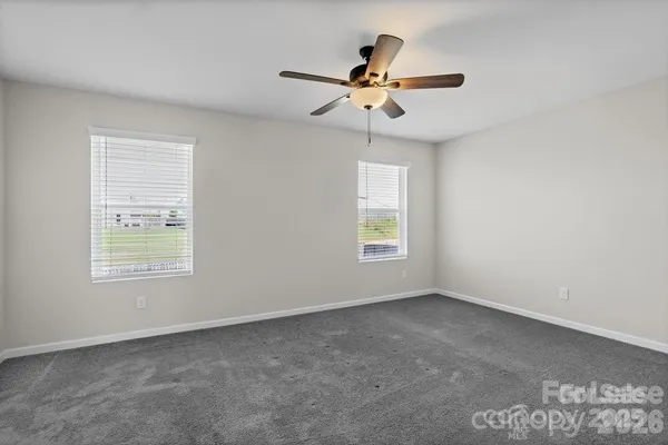 a view of a livingroom with a ceiling fan and window