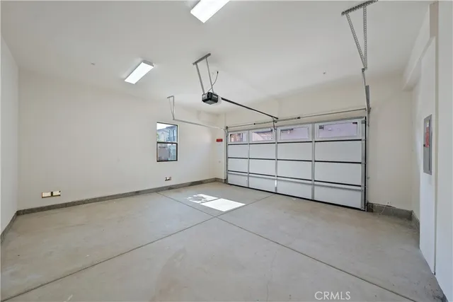 a kitchen with a refrigerator and white cabinets