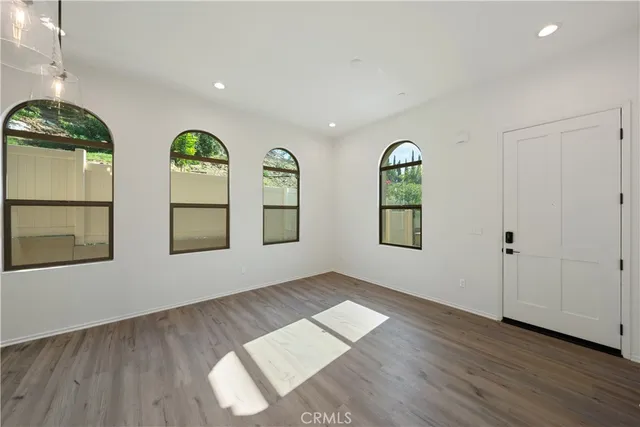 a large kitchen with granite countertop a stove a sink dishwasher and a wooden cabinets