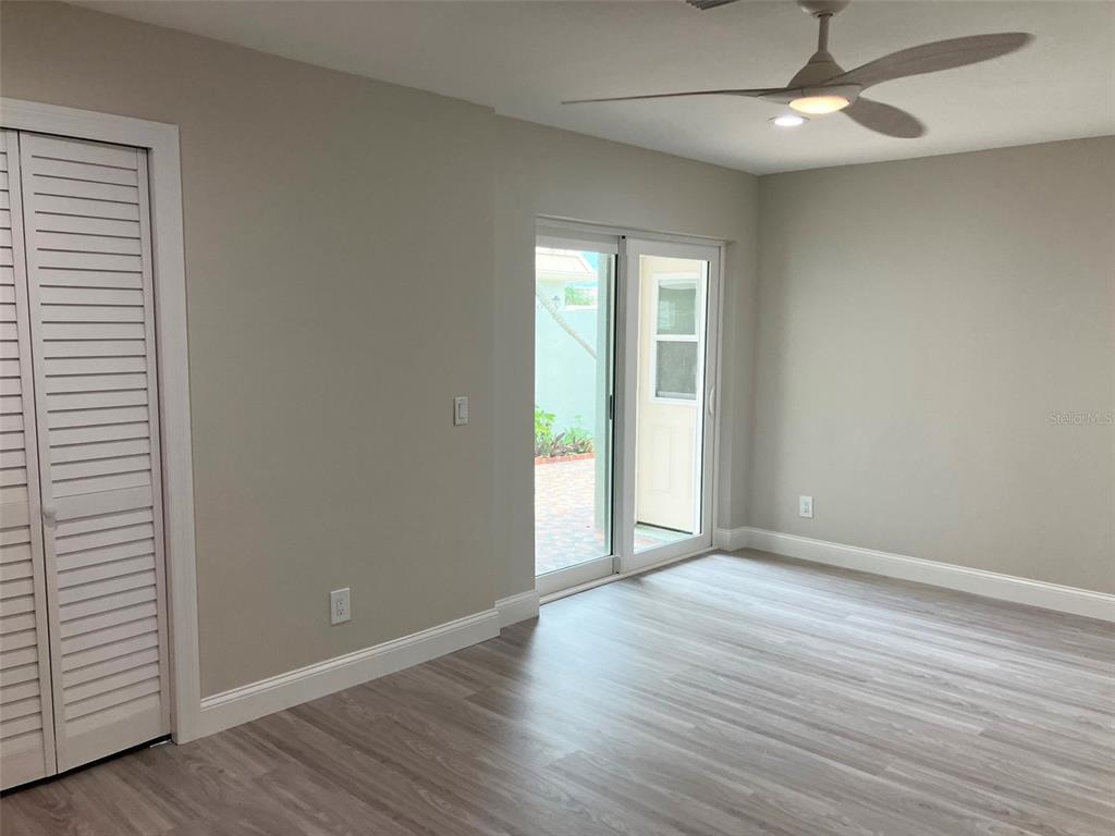 628 Boca Ciega Point Boulevard South St. Petersburg, FL 33708 - Photo 11 of 17 wooden floor in an empty room with a window