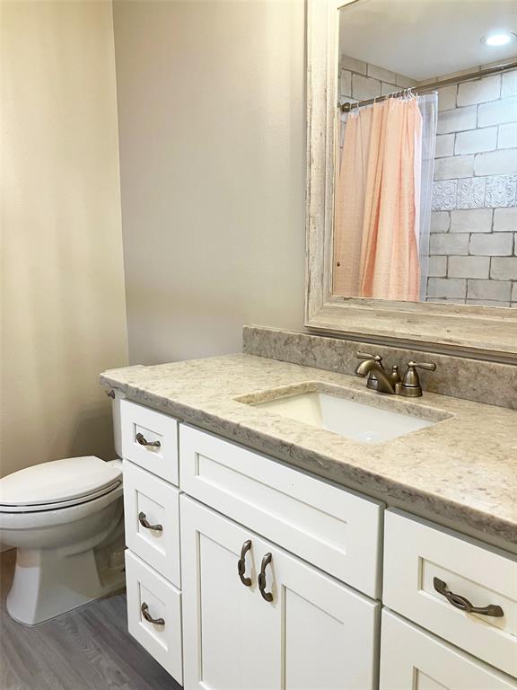 628 Boca Ciega Point Boulevard South St. Petersburg, FL 33708 - Photo 12 of 17 a bathroom with a granite countertop sink and a toilet