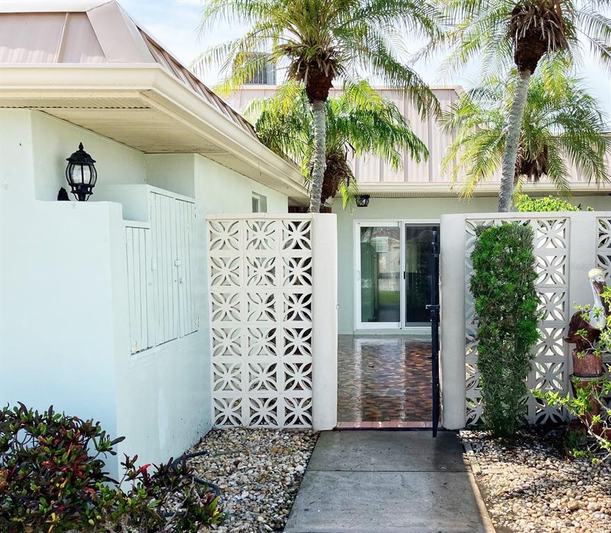 628 Boca Ciega Point Boulevard South St. Petersburg, FL 33708 - Photo 2 of 17 a front view of a house with a garden
