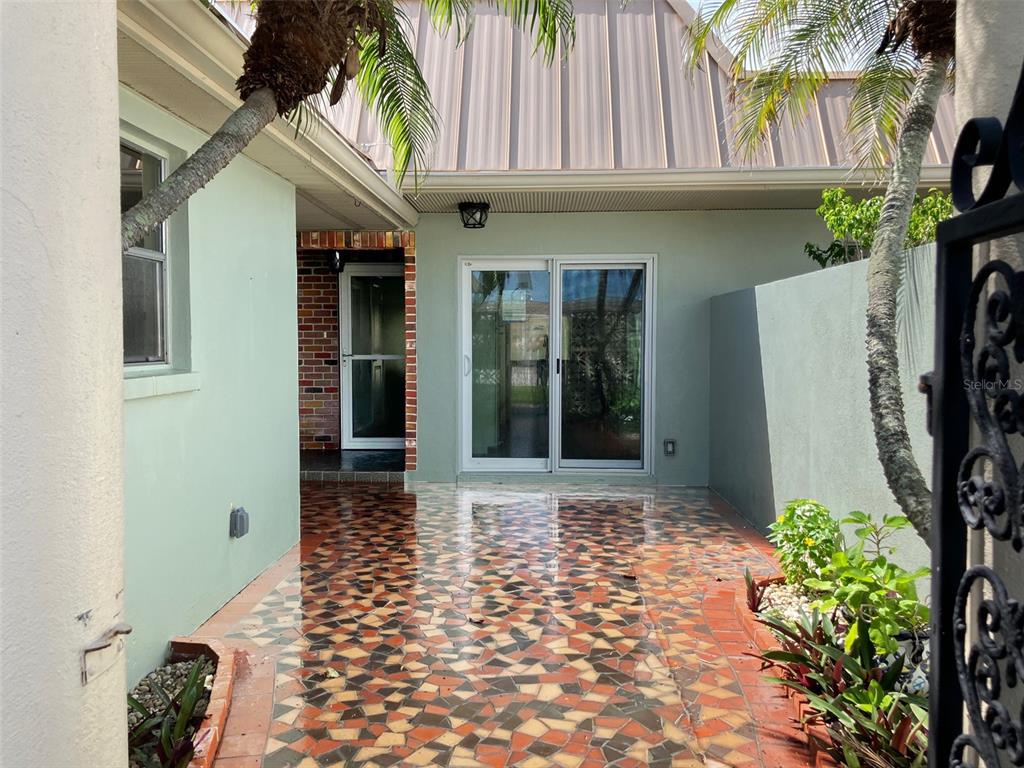 628 Boca Ciega Point Boulevard South St. Petersburg, FL 33708 - Photo 3 of 17 a view of a pathway with a house