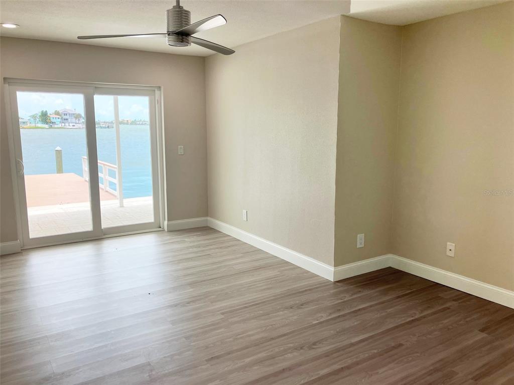 628 Boca Ciega Point Boulevard South St. Petersburg, FL 33708 - Photo 9 of 17 a view of an empty room with wooden floor and a window