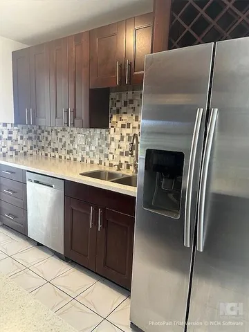 a kitchen with a sink and refrigerator