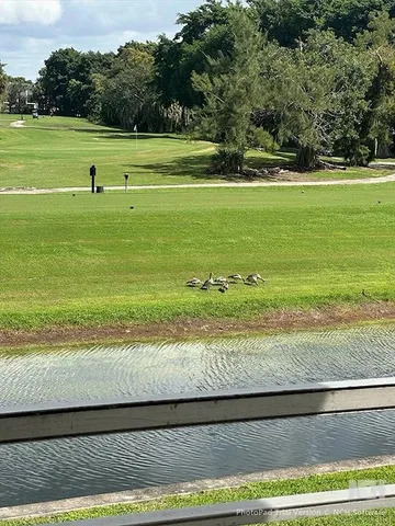 a view of a golf course with a ocean view