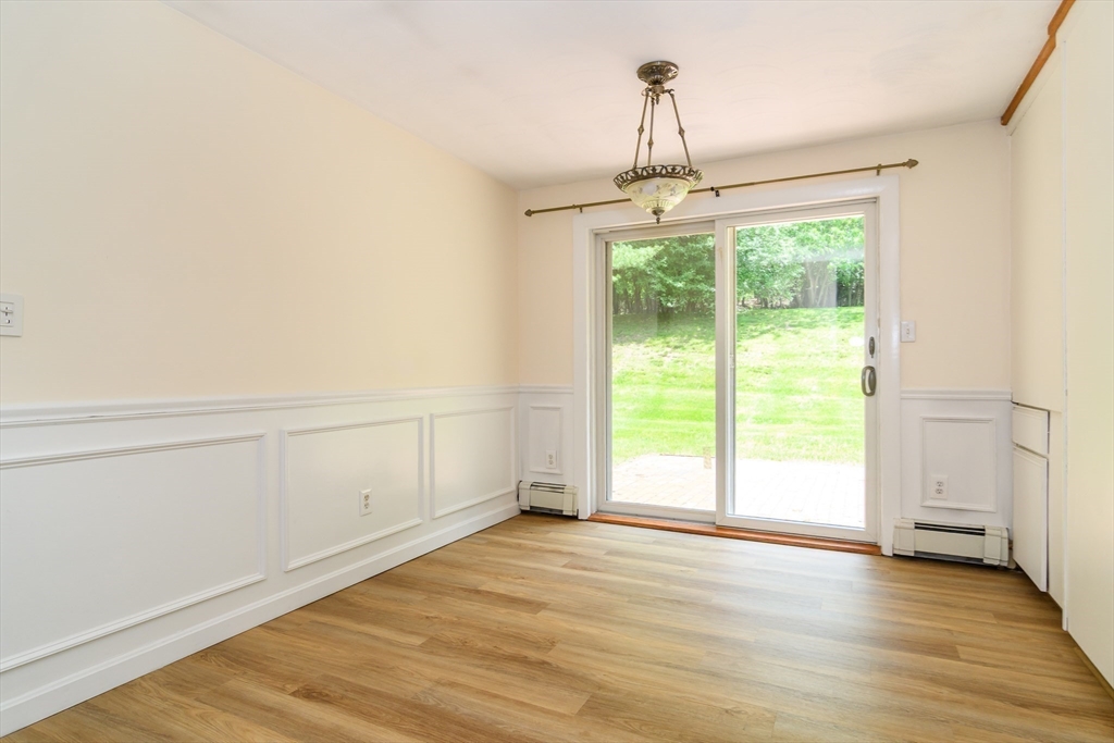33 Eisenhower Road Framingham, MA 01701 - Photo 7 of 20 a view of an empty room with wooden floor and a window